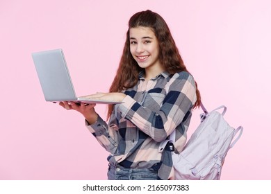 Teenage Girl Looking At Her Laptop, Getting Ready For School And Finishing Homework