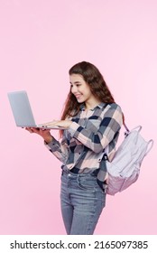 Teenage Girl Looking At Her Laptop, Getting Ready For School And Finishing Homework