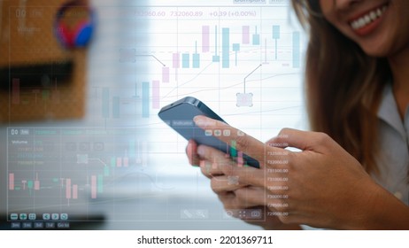 A Teenage Girl Looking At Stock Charts Or Crypto Currency Growth Through A Hologram Screen, She Is Happy To See The Growth Of Cash. Modern Investment Ideas In Stocks Or Crypto-currency.