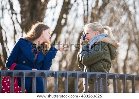 Similar – Image, Stock Photo happy twin sisters stand on a bridge and look up