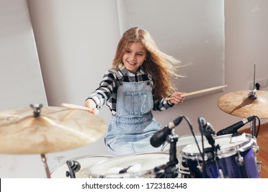 Teenage Girl Playing Drums In Studio