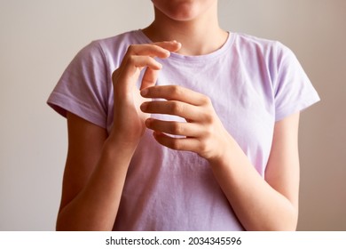 Teenage girl practicing EFT or emotional freedom technique - tapping on the karate chop point