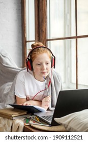 A Teenage Girl With Red Curly Hair Enjoys Listening To Music Sitting On The Windowsill. Listen To Music School Girl