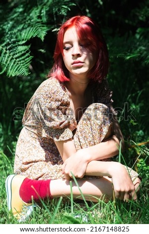 Similar – Young redhead woman surrounded by plants