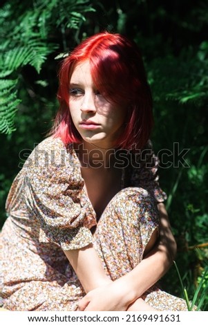 Similar – Young redhead woman surrounded by plants