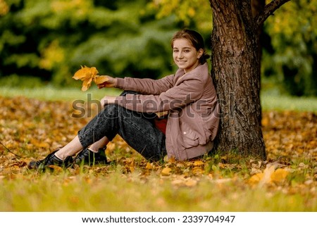 Similar – Foto Bild Herbstportrait eines glücklichen Kindes Mädchens im Garten sitzend