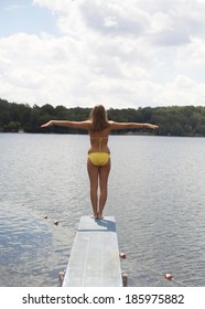 Teenage Girl Standing On Diving Board