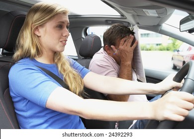 Teenage Girl Taking A Driving Lesson