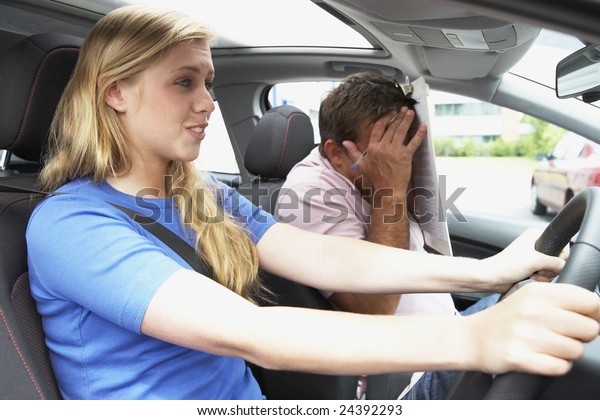 Teenage Girl Taking A\
Driving Lesson