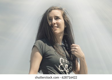 Teenage Girl Taking A Heroic Stance In The Sunlight