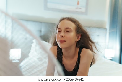 Teenage Girl Tries To Cool Off During The Intense Heat In Front Of Cooling Fan.