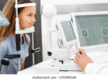 Teenage girl undergoes eye survey on special examination comuter in the ophthalmologic clinic