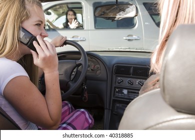 A teenage girl using her phone while driving and is going to be in a accident.
