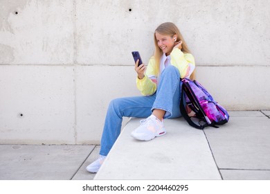 Teenage girl using mobile phone outdoors