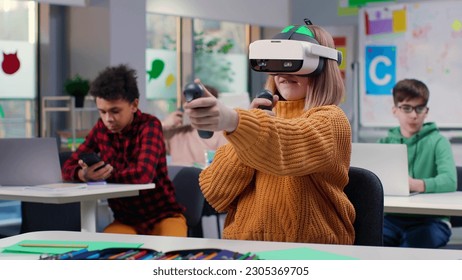 Teenage girl using vr headset in classroom. Schoolgirl in virtual reality goggles study at school