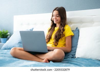 Teenage girl watching tv movie on laptop lying in bed. Teenager make video conference call online, learning online video course, relaxing in bedroom. Happy teen girl, positive and smiling emotions. - Powered by Shutterstock