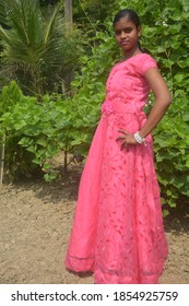 A Teenage Girl Wearing A Pink Frock With Gold Chain, Nose Pin And White Bangles,  Selective Focusing