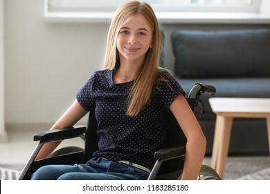 Teenage girl in wheelchair at home