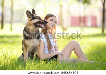 Similar – Pretty blond woman with her two dogs