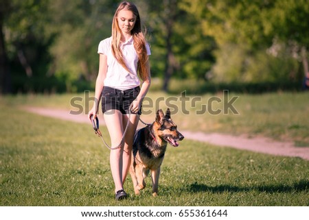 Similar – Attractive smiling blond woman with her two dogs