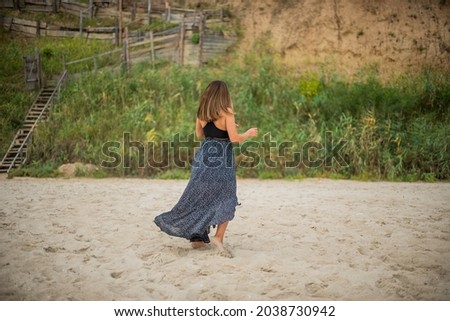 Сute teenage girl or woman on the beach nature landscape fresh air beach. Natural beauty. lifestyle real people funny dance.