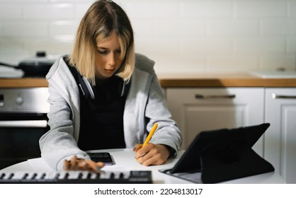 Teenage Girl Writing Composing Music At Home.