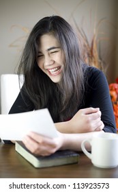 Teenage Girl Or Young Woman Happily Reading Note In Hand