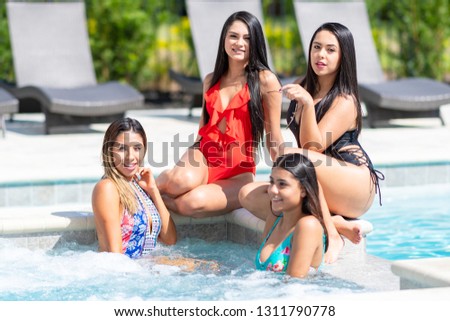 Teenage girls having fun at a pool party in the summer