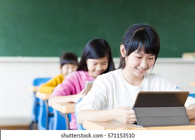  teenage girls student watching the tablet in classroom