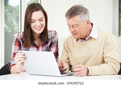 Teenage Granddaughter Showing Grandfather How To Use Laptop Computer - Powered by Shutterstock