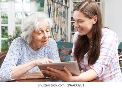 Teenage Granddaughter Showing Grandmother How To Use Digital Tablet - Powered by Shutterstock