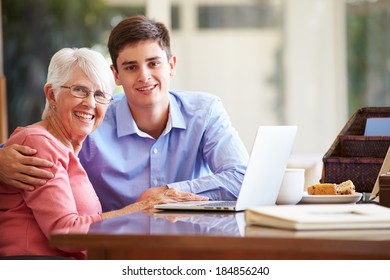 Teenage Grandson Helping Grandmother With Laptop