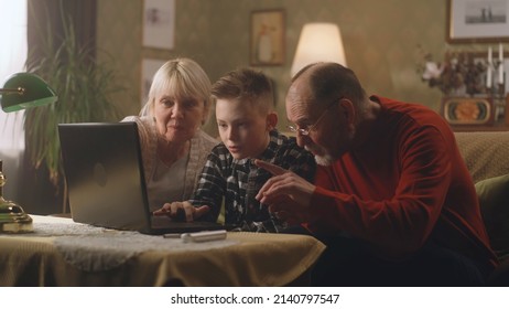 A Teenage Grandson Talking To His Retired Grandparents How A New Modern Laptop And Applications Working