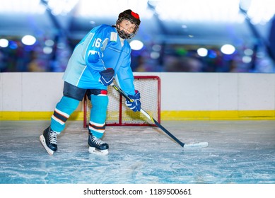 Teenage hockey player during practice at ice arena - Powered by Shutterstock