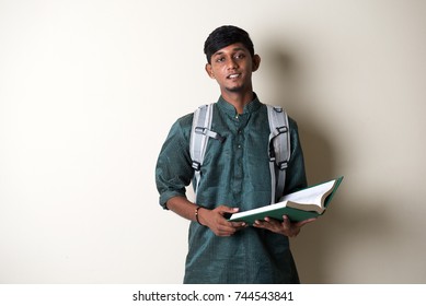 Teenage Indian Male In Traditional Dress Reading Books