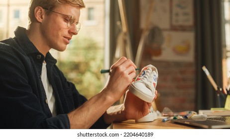 Teenage Male Artist Customising Footwear by Painting it at his Workplace  Creative Freelancer Making Organic   Fashionable Design for Shoes  Talented Millennial People Concept 