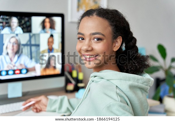 Teenage mixed race girl high school student\
distance e learning group online class at home looking at camera.\
Video conference call remote class, course, virtual digital\
education, headshot\
portrait.