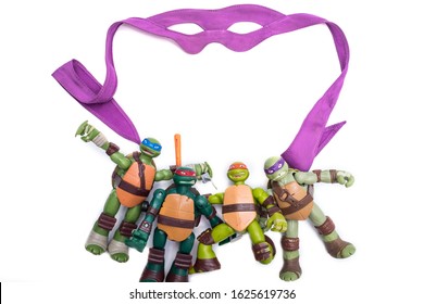 Teenage mutant ninja turtles figures and mask isolated on a white background
