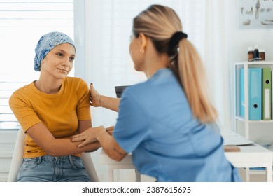 Teenage oncology patient talking with doctor. Oncologist treating teen girl with cancer and provide emotional support, helping her with anxiety and depression. - Powered by Shutterstock