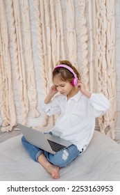 Teenage pupil using laptop notebook preparing for exams at home. Girl in headphone study online with video call, learn english language listen lecture. People, remote education, technology concept. - Shutterstock ID 2253163953