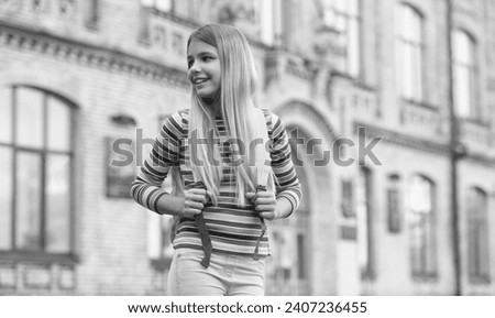 Similar – Happy young woman with moving hair in urban background