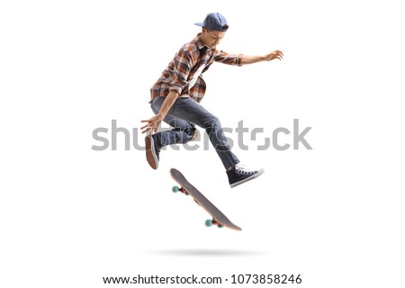 Teenage skater performing a trick with a skateboard isolated on white background