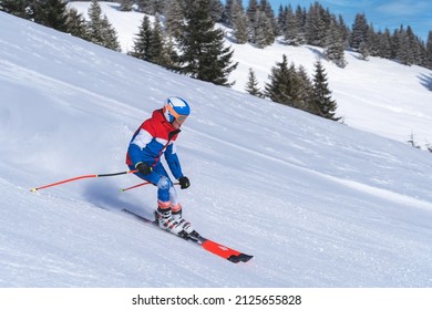 
				A teenage skier skiies down the montain.With copy space