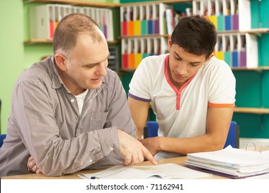 Teenage Student In Classroom With Tutor