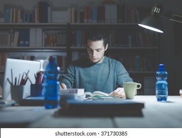 Teenage Student Reading Books And Studying Late At Night, Learning And Education Concept