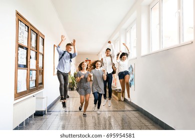 Teenage Students In High School Hall Jumping High.