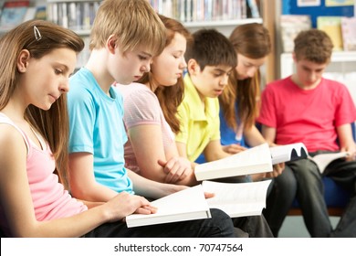 Teenage Students In Library Reading Books