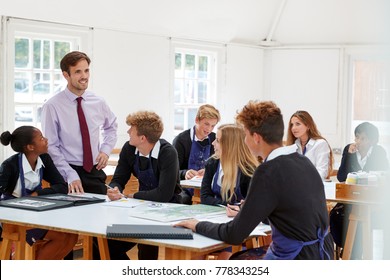 Teenage Students Listening To Teacher In Art Class