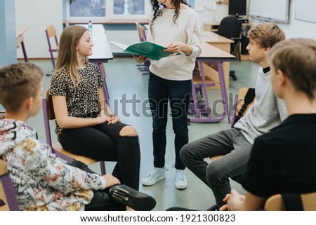 Similar – Image, Stock Photo a child sits on the wooden floor and reads a book while the sun shines on it