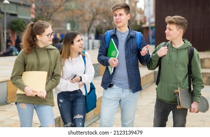 Teenage students spending time together after lessons, talking and having fun outdoors - Shutterstock ID 2123139479